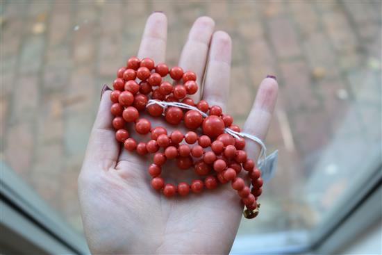 A single strand graduated coral bead necklace, with yellow metal clasp, gross weight 53 grams, 64cm.